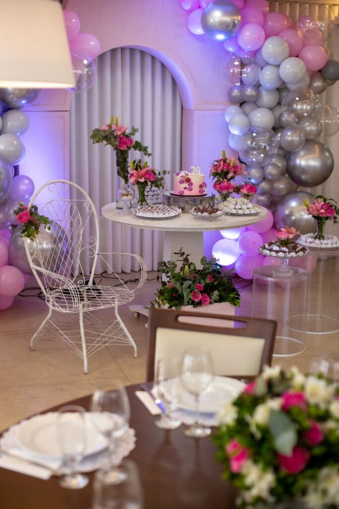 Vibrant indoor setup featuring balloons and floral decor for a celebration.